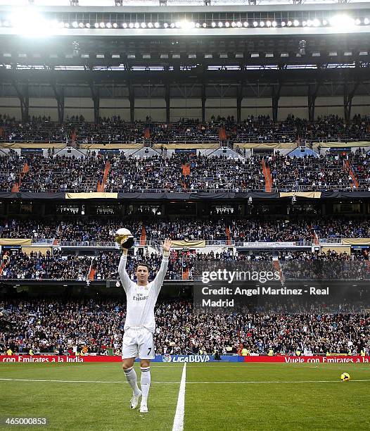 Cristiano Ronaldo of Real Madrid holds the Ballon d'Or 2014 award prior the La Liga match between Real Madrid and Granada CF at Estadio Santiago...