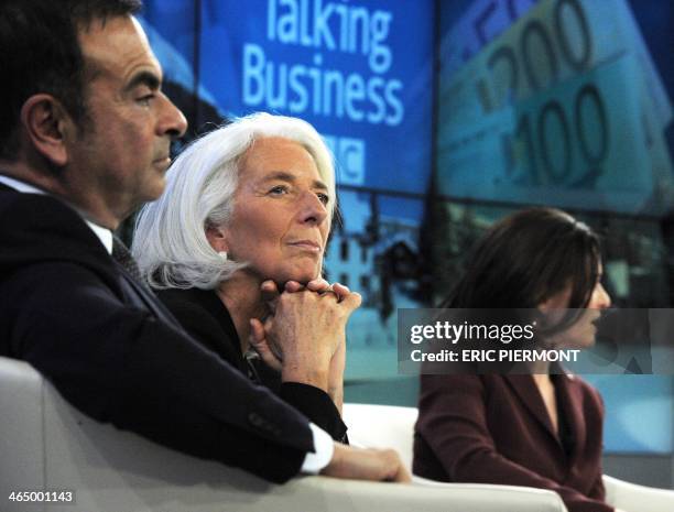 International Monetary Fund Managing Director Christine Lagarde listens with other session participants, among them Renault-Nissan CEO Carlos Ghosn...
