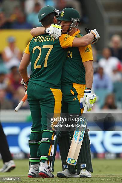 Rilee Rossouw of South Africa celebrates his half century with David Miller of South Africa during the 2015 ICC Cricket World Cup match between South...