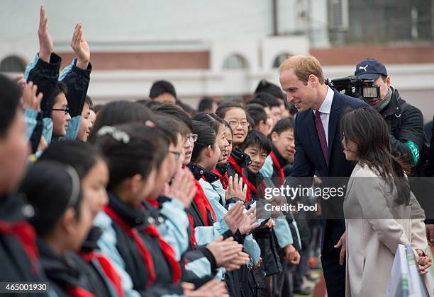 Prince William, Duke of Cambridge greets pupils as he attends a Premier Skills Football Event on March 3, 2015 in Shanghai, China. Prince William,...