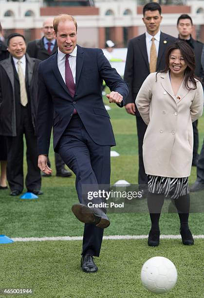 Prince William, Duke of Cambridge kicks a ball as he attends a Premier Skills Football Event on March 3, 2015 in Shanghai, China. Prince William,...