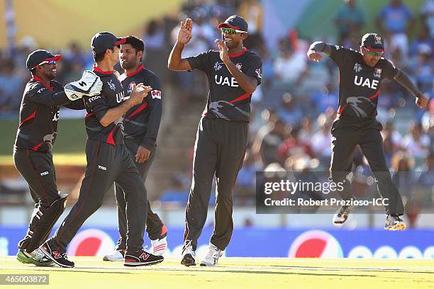 Players celebrate after Mohammad Naveed of UAE takes the wicket of Shikhar Dhawan of India during the 2015 ICC Cricket World Cup match between India...