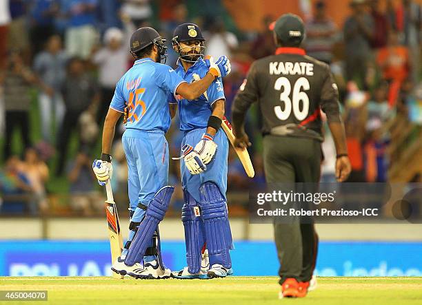 Rohit Sharma of India and Virat Kohli of India celebrate a win during the 2015 ICC Cricket World Cup match between India and the United Arab Emirates...