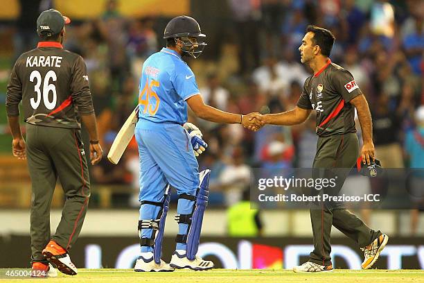 Rohit Sharma of India and Mohamed Tauqir of UAE shake hands after an India win during the 2015 ICC Cricket World Cup match between India and the...