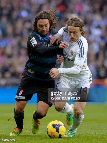 Granada's midfielder Fran Rico vies with Real Madrid's Croatian midfielder Luka Modric during the Spanish league football match Real Madrid vs FC...