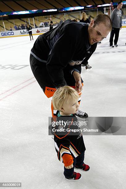 Mark Fistric of the Anaheim Ducks skates with his son during the family skate following team practice for the 2014 Coors Light NHL Stadium Series...