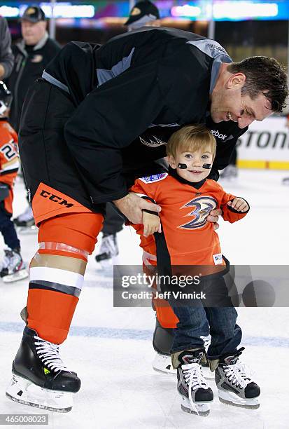 Francois Beauchemin of the Anaheim Ducks skates with his son during the family skate after the team practice for the 2014 Coors Light NHL Stadium...