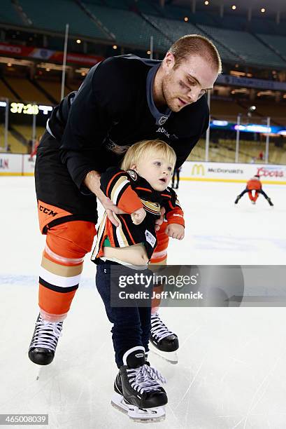 Mark Fistric of the Anaheim Ducks skates with his son during the family skate after the team practice for the 2014 Coors Light NHL Stadium Series...