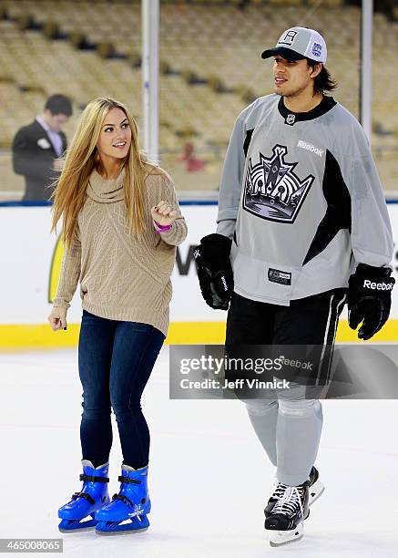 Jordan Nolan of the Los Angeles Kings skates with his girlfriend Laura during the family skate after the team practice for the 2014 Coors Light NHL...