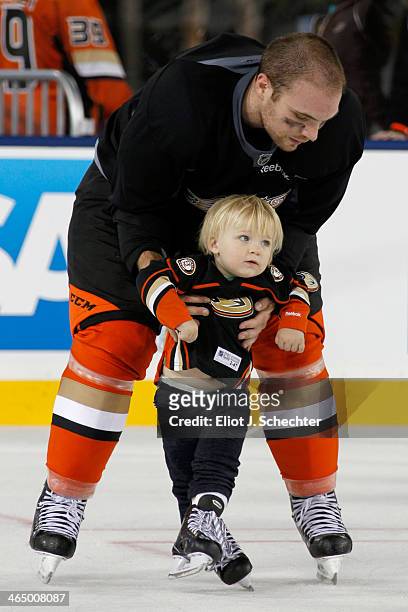 Mark Fistric of the Anaheim Ducks skates with his son during the family skate following team practice for the 2014 Coors Light NHL Stadium Series...