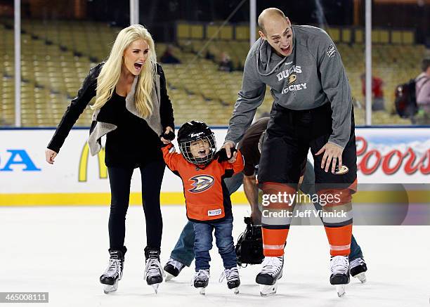 Ryan Getzlaf of the Anaheim Ducks skates with his wife Paige Getzlaf and son Ryder during the family skate after the team practice for the 2014 Coors...