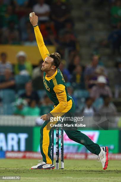 Faf du Plessis of South Africa bowls during the 2015 ICC Cricket World Cup match between South Africa and Ireland at Manuka Oval on March 3, 2015 in...