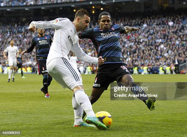 Jese Rodriguez of Real Madrid kicks the ball under pressure from Brayan Angulo of Granada during the La Liga match between Real Madrid and Granada CF...