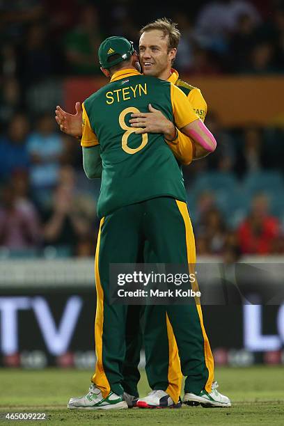 Dale Steyn of South Africa congratulates AB de Villiers of South Africa celebrates taking the wicket of John Mooney of Ireland during the 2015 ICC...