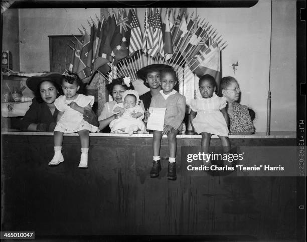 Group portrait of women holding babies and children, including Andrew Lee Dixon holding document, Andrea Lark Williams, Diane Banks, Patricia Elaine...