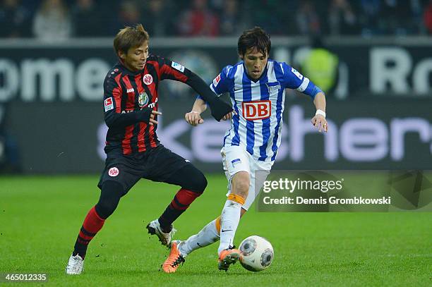 Takashi Inui of Eintracht Frankfurt and Hajime Hosogai of Hertha BSC battle for the ball during the Bundesliga match between Eintracht Frankfurt and...