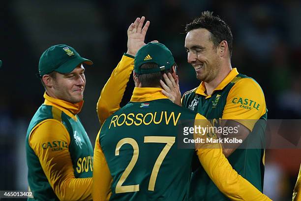 David Miller, Rilee Rossouw and Kyle Abbott of South Africa celebrates taking the wicket of Kevin O'Brien of Ireland during the 2015 ICC Cricket...