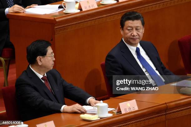 Chinese President Xi Jinping looks at Chairman of the Standing Committee of China's National People's Congress , Zhang Dejiang at the opening session...