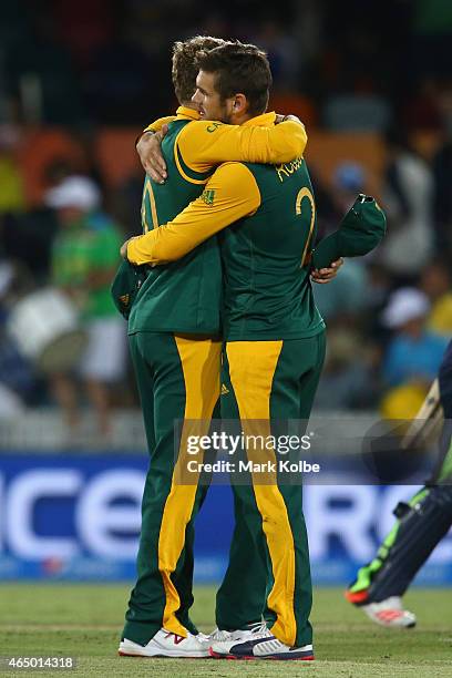 David Miller and Rilee Rossouw of South Africa celebrate victory during the 2015 ICC Cricket World Cup match between South Africa and Ireland at...