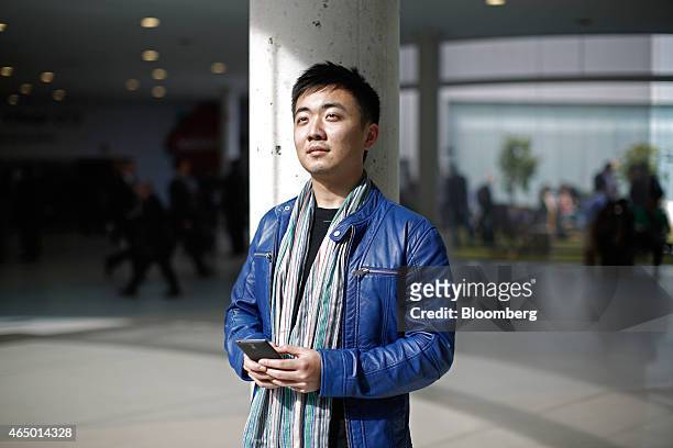 Carl Pei, co-founder of OnePlus, poses for a photograph with a OnePlus One smartphone at the Mobile World Congress in Barcelona, Spain, on Monday,...