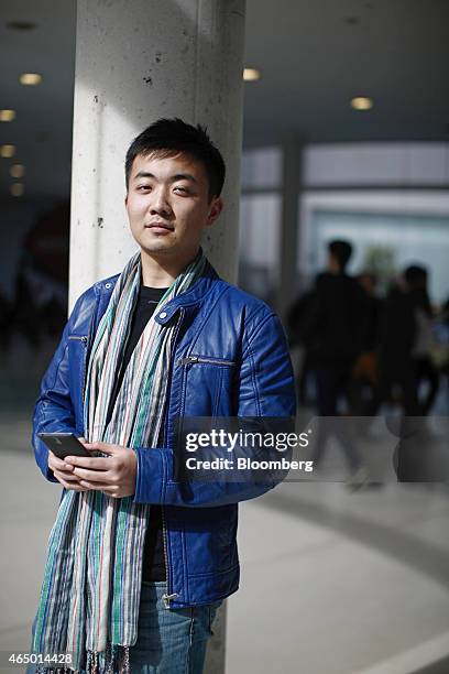 Carl Pei, co-founder of OnePlus, poses for a photograph with a OnePlus One smartphone at the Mobile World Congress in Barcelona, Spain, on Monday,...