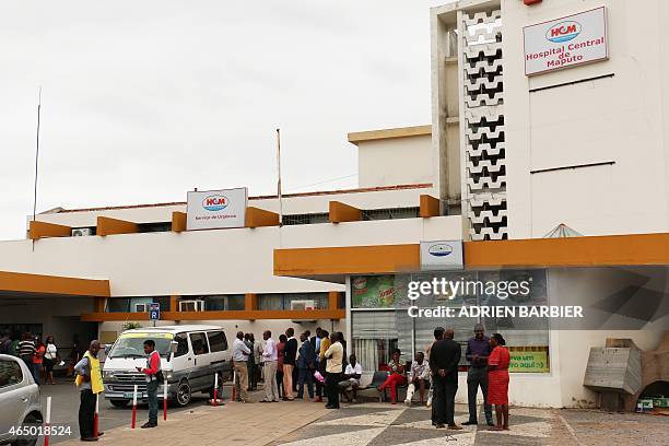 People gather on March 3, 2015 outside the Maputo Central Hospital where a Franco-Mozambican Constitutional law expert, Gilles Cistac, with close...
