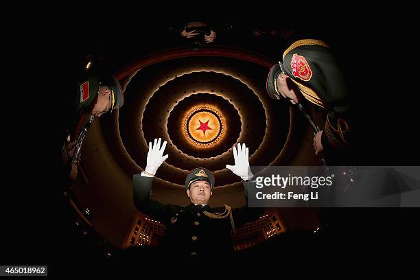 Conductor of a military band performs during a rehearsal before the opening session of the Chinese People's Political Consultative Conference at the...