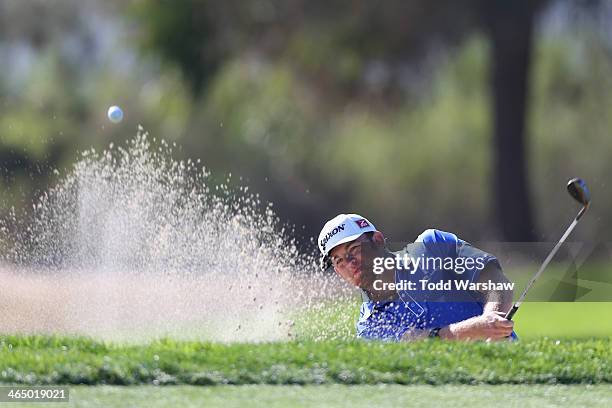 Holmes hits a shot out of a bunker on the 6th hole during the third round of the Farmers Insurance Open on Torrey Pines South on January 25, 2014 in...