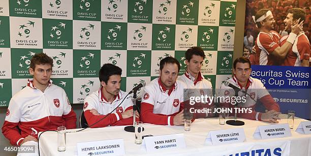 Swiss players Henri Laaksonen, Yann Marti, coach Severin Luthi, Adrien Bossel and Michael Lammer give a press conference on March 3, 2015 ahead of...