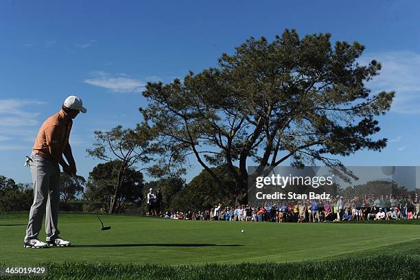 Jordan Spieth hits a putt on the 8th green during the third round of the Farmers Insurance Open on Torrey Pines South on January 25, 2014 in La...