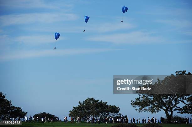 Paragliders fly over the Torrey Pines South course during the third round of the Farmers Insurance Open on January 25, 2014 in La Jolla, California.