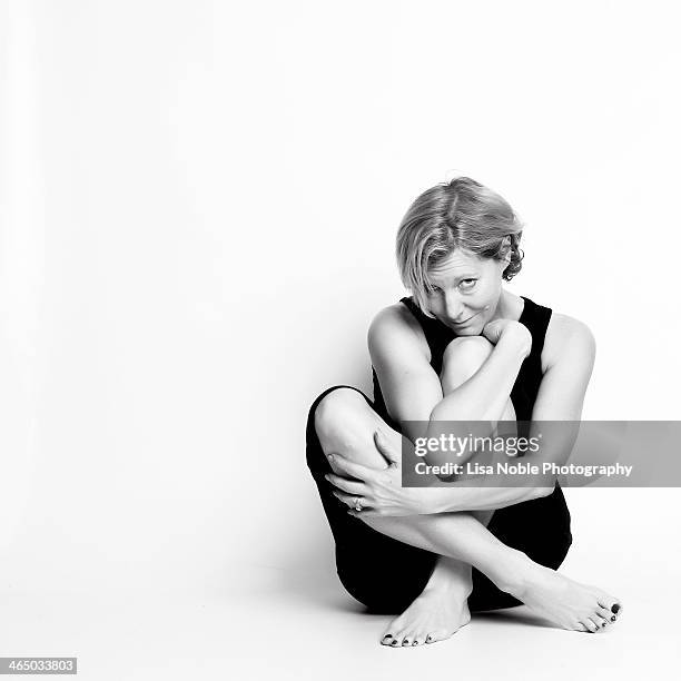 woman in exercise clothes sitting - hugging knees stock pictures, royalty-free photos & images