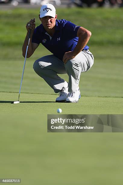 Gary Woodland assesses a putt on the 18th green during the third round of the Farmers Insurance Open on Torrey Pines South on January 25, 2014 in La...