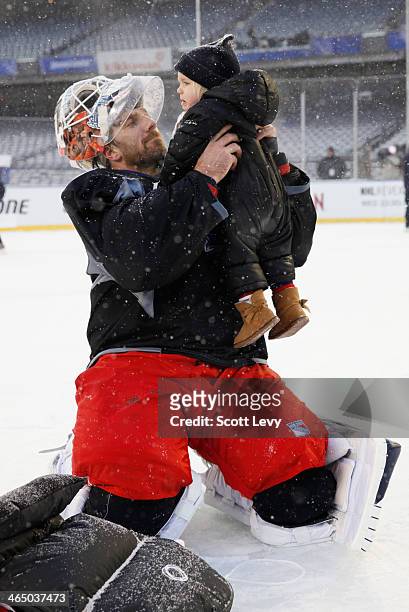Henrik Lundqvist of the New York Rangers skates with his family during the 2014 NHL Stadium Series practice session and family skate at Yankee...