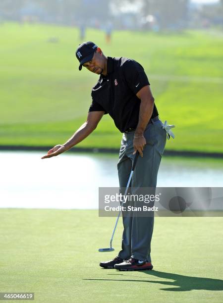 Tiger Woods reacts to his putt on the 18th hole during the third round of the Farmers Insurance Open at Torrey Pines Golf Course on January 25, 2014...