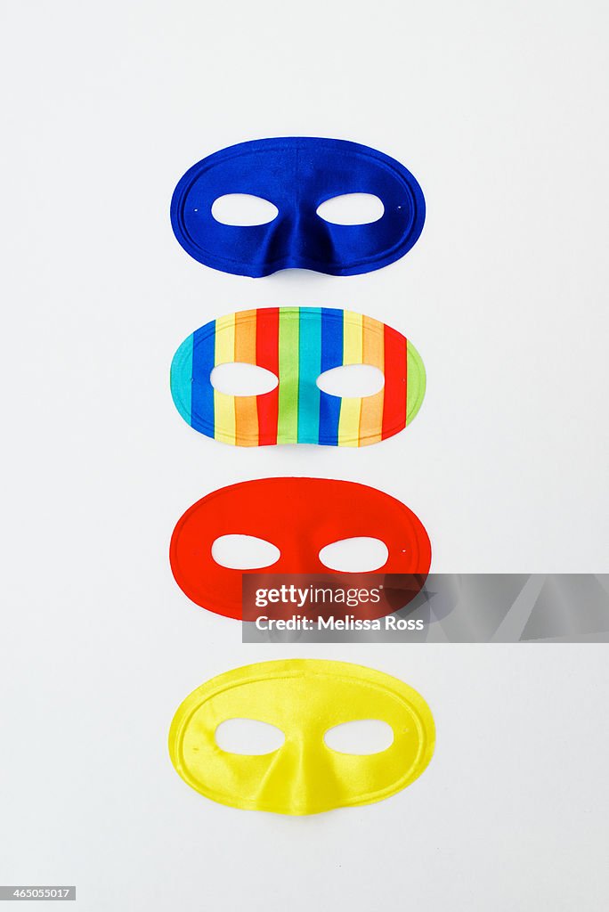 Colorful costume masks arranged in a vertical row