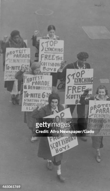 Communist Party of the United States' members prepare for a march to protest the conviction of Haywood Patterson and Clarence Norris, two of the boys...