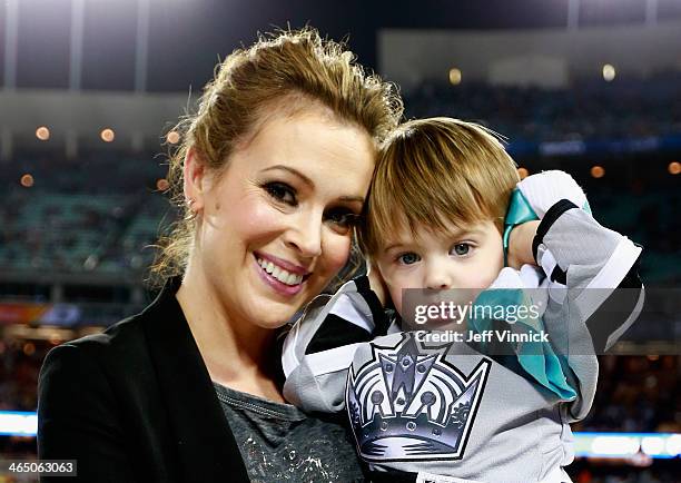 Actress Alyssa Milano holds son Milo at the 2014 Coors Light NHL Stadium Series between the Los Angeles Kings and the Anaheim Ducks at Dodger Stadium...