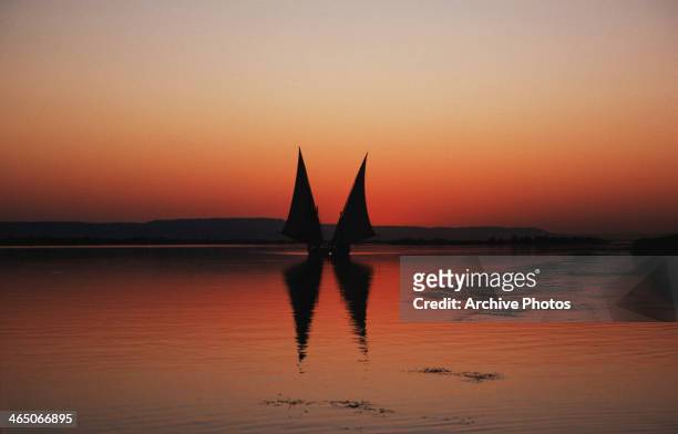 Two feluccas on the River Nile at sunset, Egypt, July 1964.