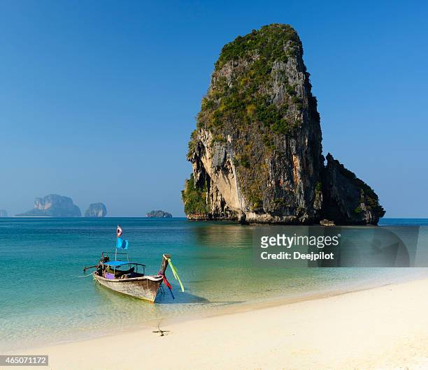 longtail boat on railay beach thailand - krabi stock pictures, royalty-free photos & images
