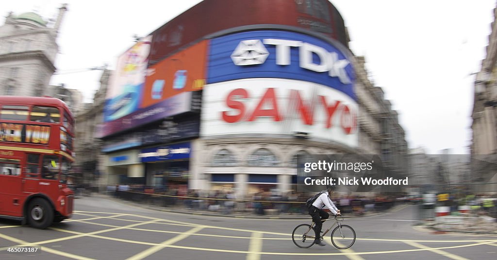 Business man cycling Piccadilly Circus