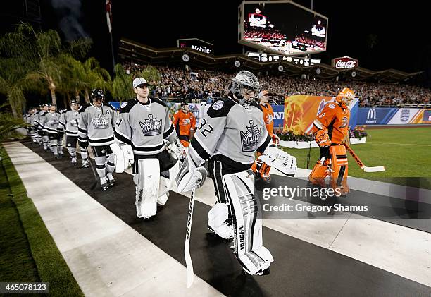 Goaltenders Jonathan Quick of the Los Angeles Kings and Jonas Hiller of the Anaheim Ducks enter Dodger Stadium before the 2014 Coors Light NHL...