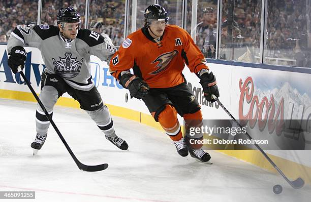 Teemu Selanne of the Anaheim Ducks handles the puck against Alec Martinez of the Los Angeles Kings during the 2014 Coors Light NHL Stadium Series on...