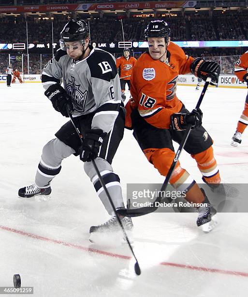 Tim Jackman of the Anaheim Ducks battles for the puck against Jake Muzzin of the Los Angeles Kings during the 2014 Coors Light NHL Stadium Series on...