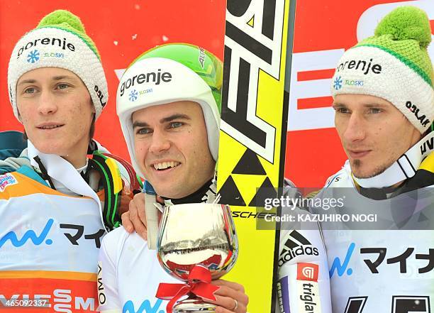 Slovenian winners of the men's ski-jumping World Cup competition, first place Jernej Damjan , second place Peter Prevc , and third place Robert...