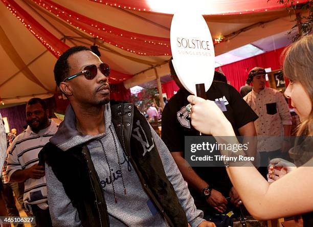 Rapper Juicy J wearing Carrera sunglasses with the Solstice Sunglasses and Safilo USA display at the GRAMMY Gift Lounge during the 56th GRAMMY Awards...