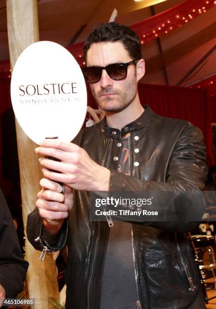 Recording artist Ryan Merchant wearing Carrera sunglasses with the Solstice Sunglasses and Safilo USA display at the GRAMMY Gift Lounge during the...