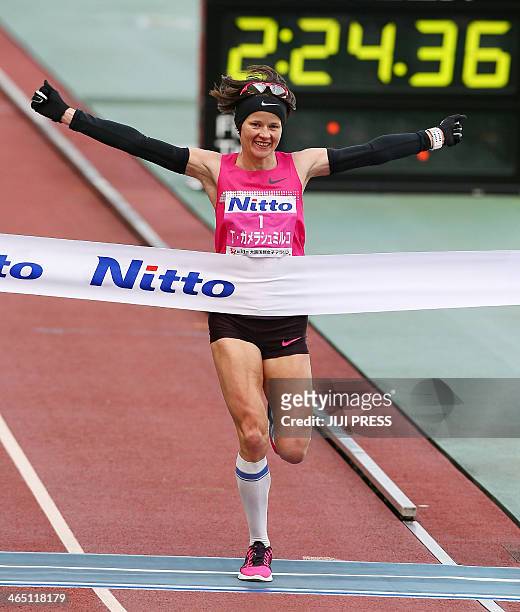 Tetiana Gamera-Shmyrko of Ukraine raises her arms as she crosses the finish line in the Osaka women's marathon in Osaka, western Japan, on January...