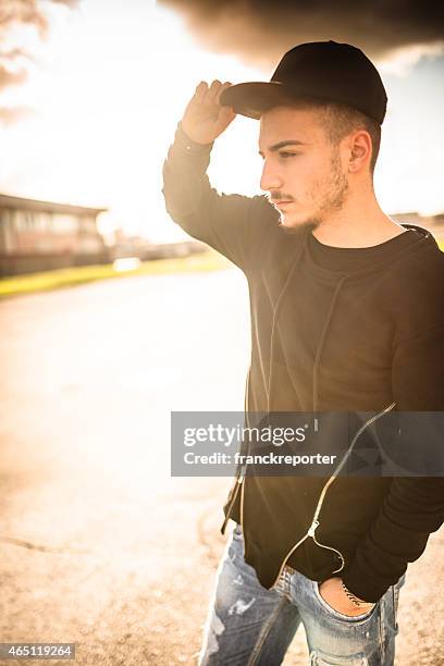 fashionable young adult looking away at dusk - all hip hop models stock pictures, royalty-free photos & images