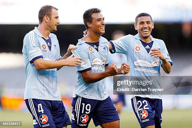 Nick Carle of Sydney is congratulated by team mates Ranko Despotovic and Ali Abbas after scoring a goal during the round 16 A-League match between...